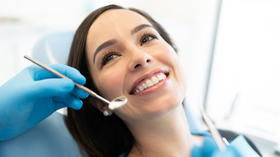Woman Wondering What Happens At First Dental Appointment