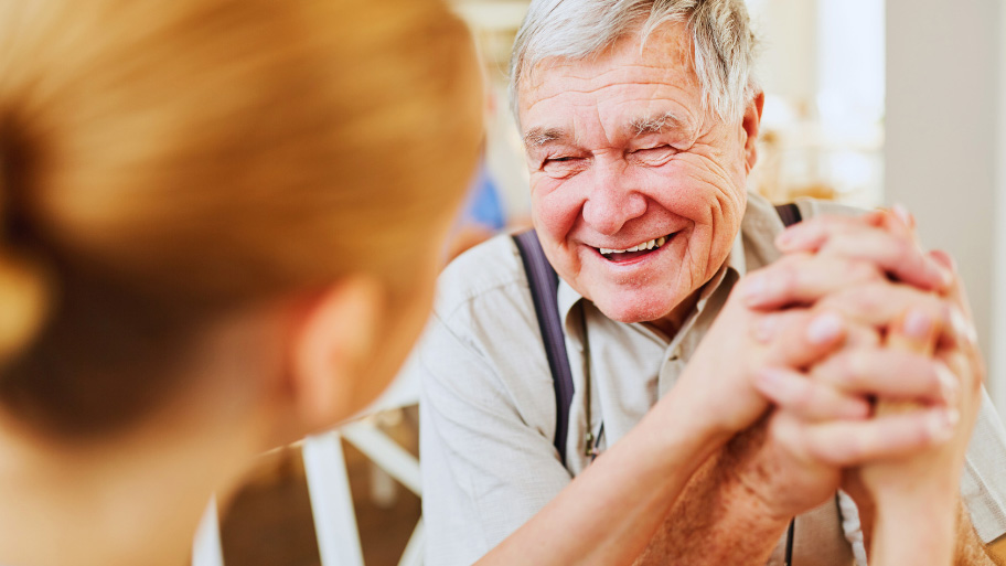 Old Man Happily Talking to a Dentist - Dental Care for Seniors