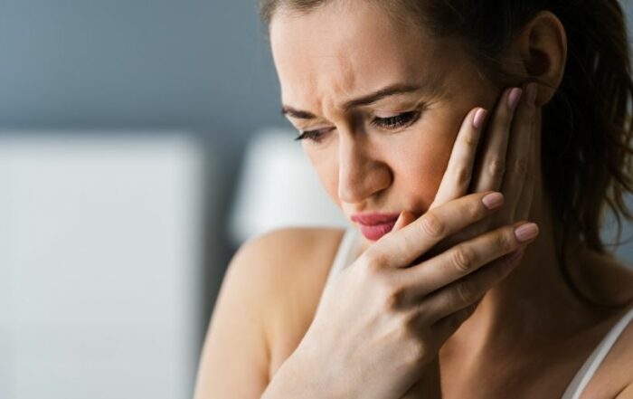 Woman having toothache - How to Manage Dental Pain at Home